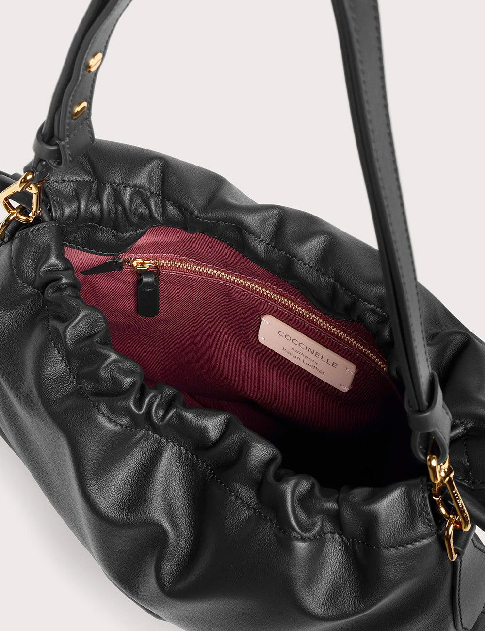 Black leather coccinelle lidia small noir handbag with plush burgundy interior and gold-tone hardware