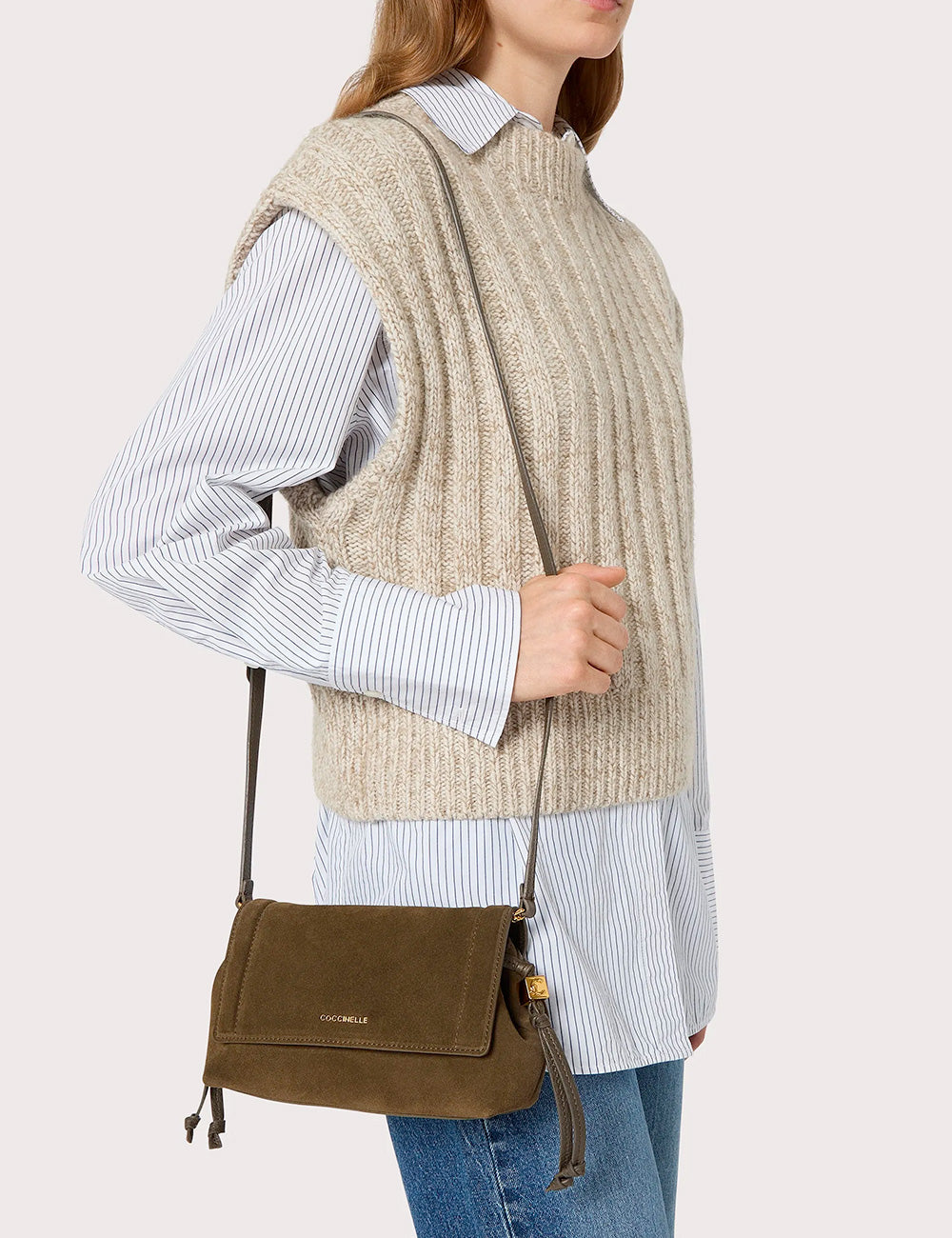 Olive green suede crossbody bag with gold-tone hardware and drawstring detail from Coccinelle Thess Suede Mini Fango