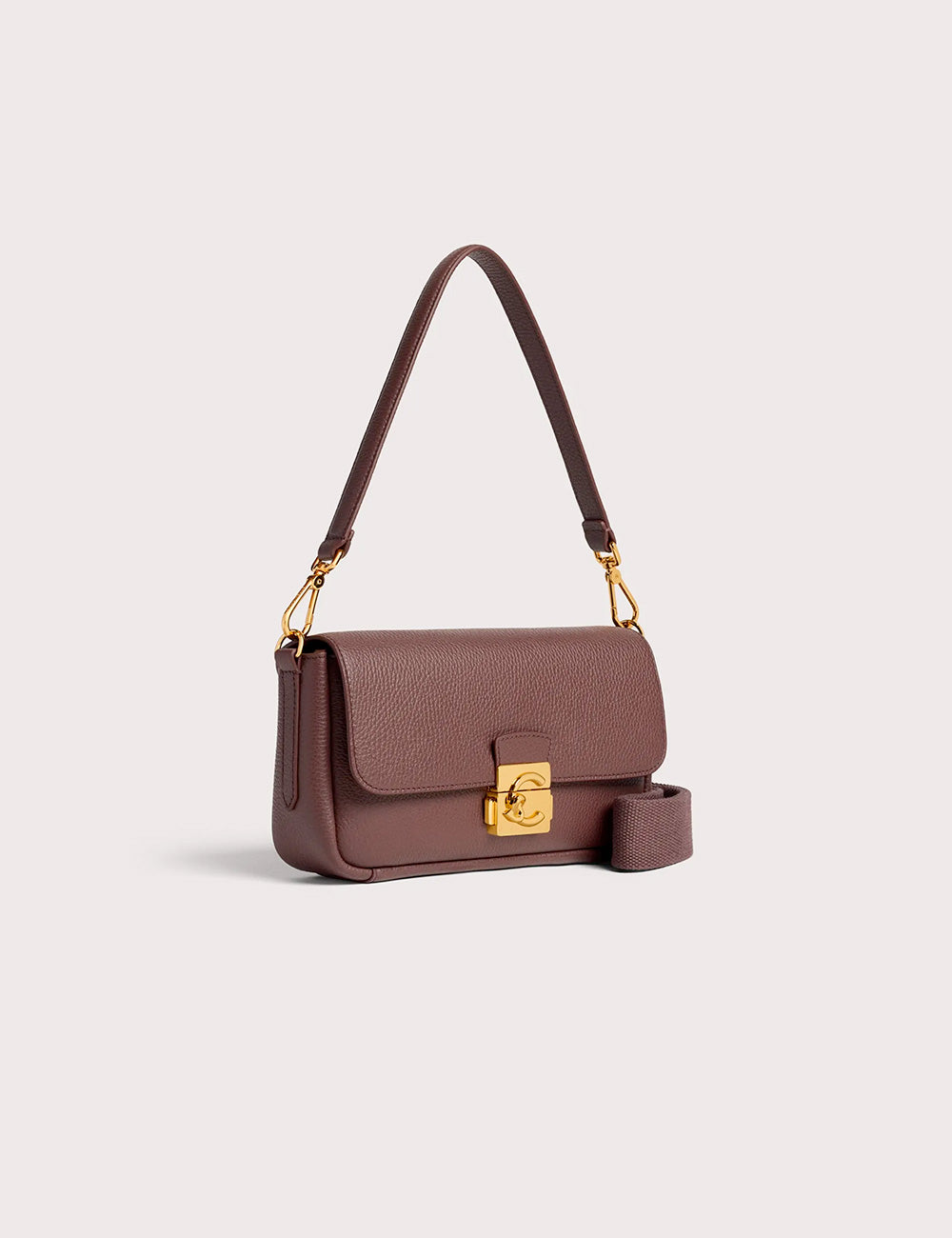 A brown textured leather crossbody bag coccinelle c-me lock medium berry with gold-tone clasp and adjustable strap