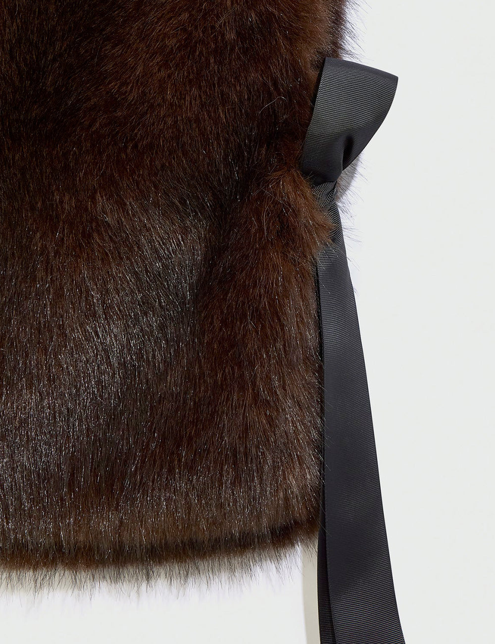 Rich brown faux fur coat liviana conti pettorina patricia ebano with sleek black satin ribbon bow at the side