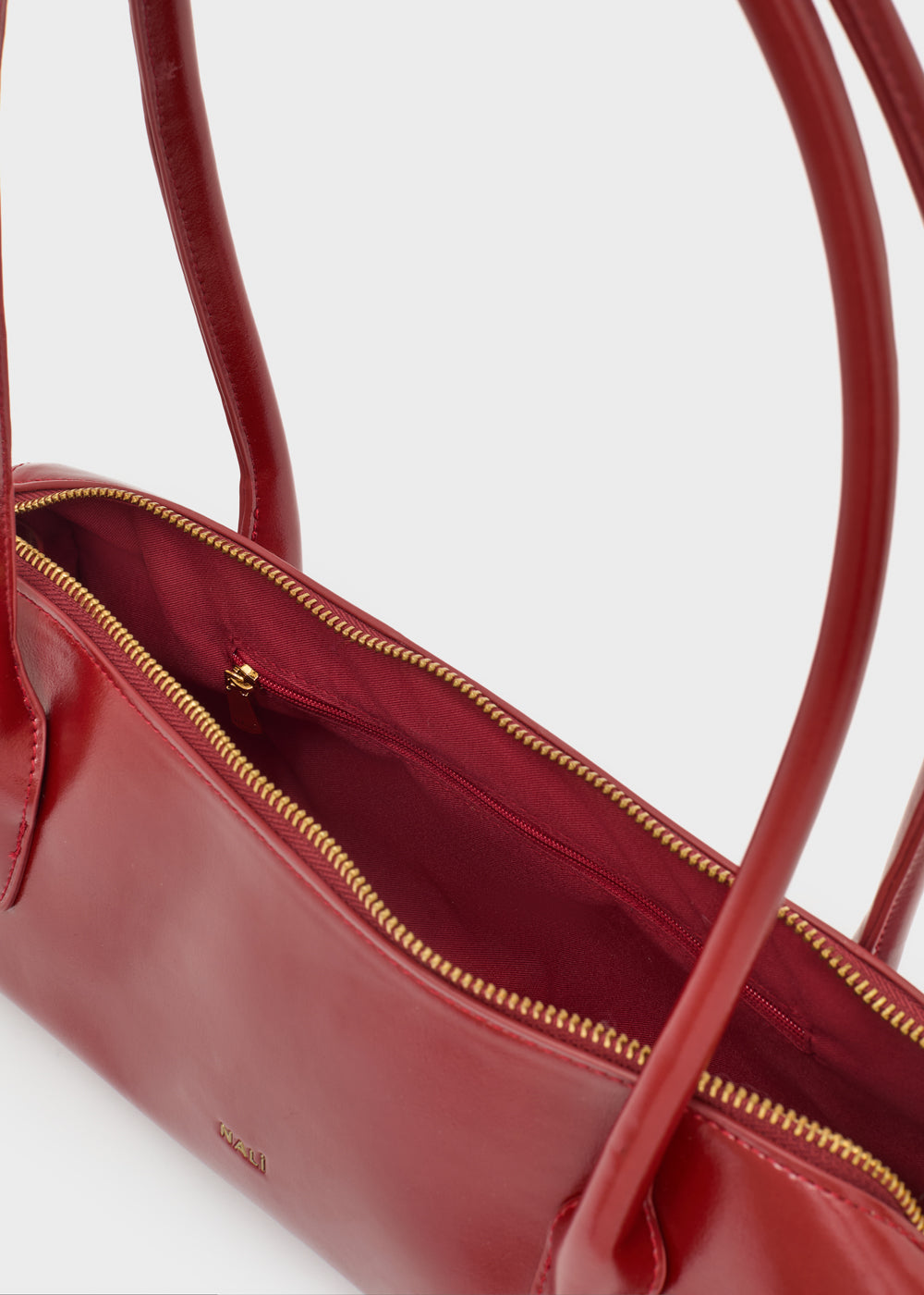 Rosso nalì a spalla billie baguette handbag in pelle lucida con zip dorate e manici strutturati
