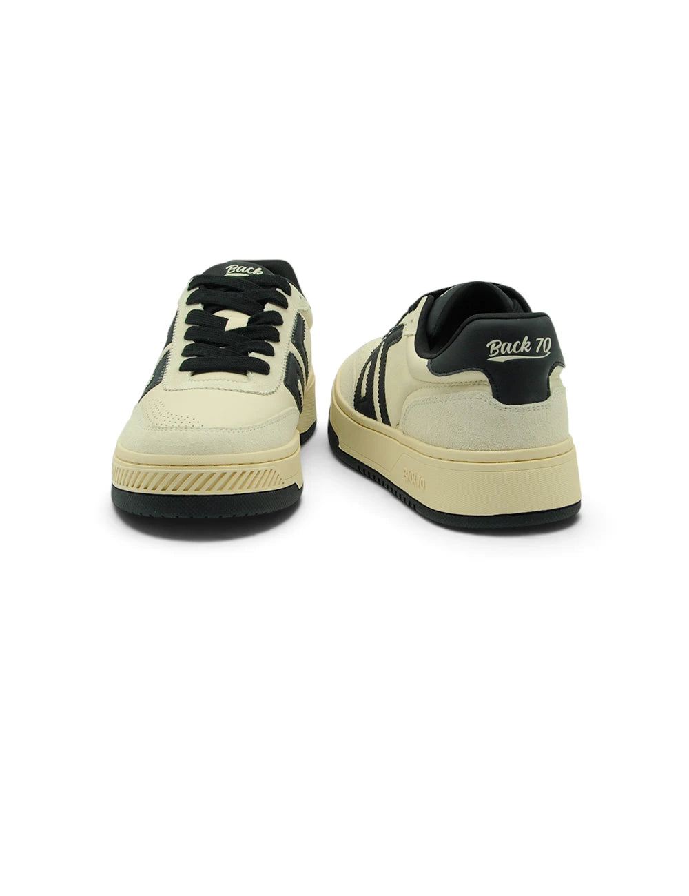 Cream-colored Back 70 sneakers with black laces three bold stripes and white back 70 logo on heel tab shown from back side