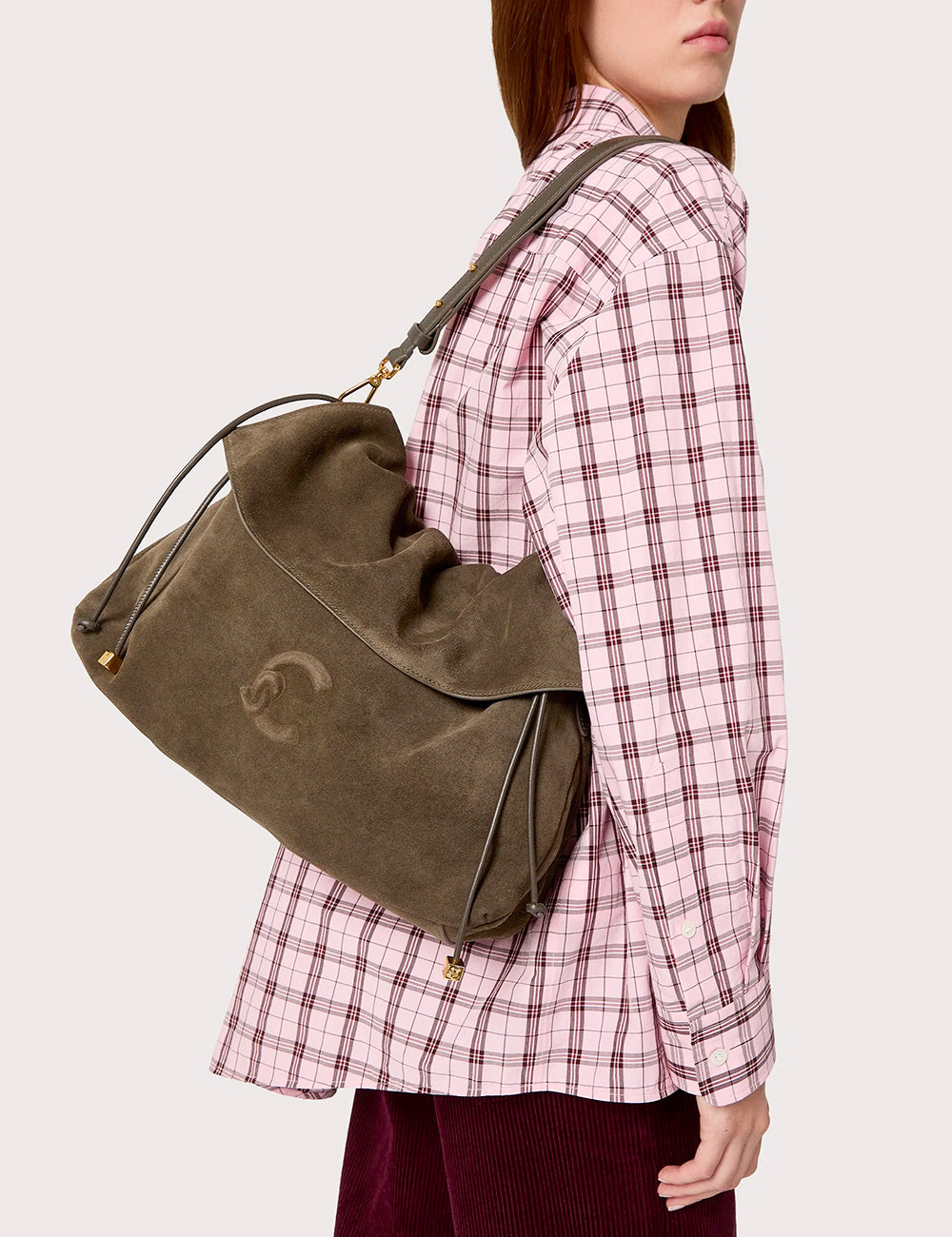Olive green suede shoulder bag with subtle embroidered logo and gold-tone hardware by Coccinelle Lidia Suede Medium Fango
