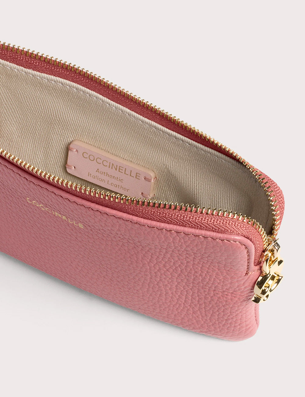 A zippered soft pink coccinelle c me softy small pouch in textured italian leather with gold tone hardware winter rose