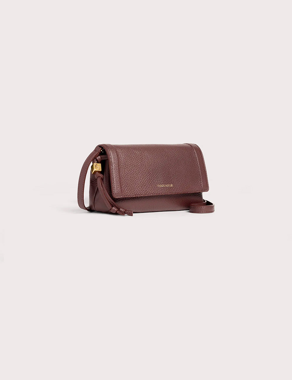 Brown textured leather crossbody bag with gold tone clasp and adjustable strap coccinelle thess mini berry