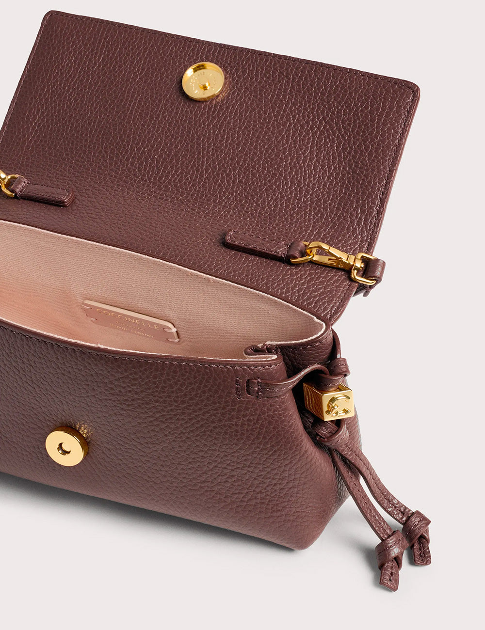 Coccinelle Thess Mini Berry clutch marrone in pelle con texture e chiusura a coulisse con dettagli oro