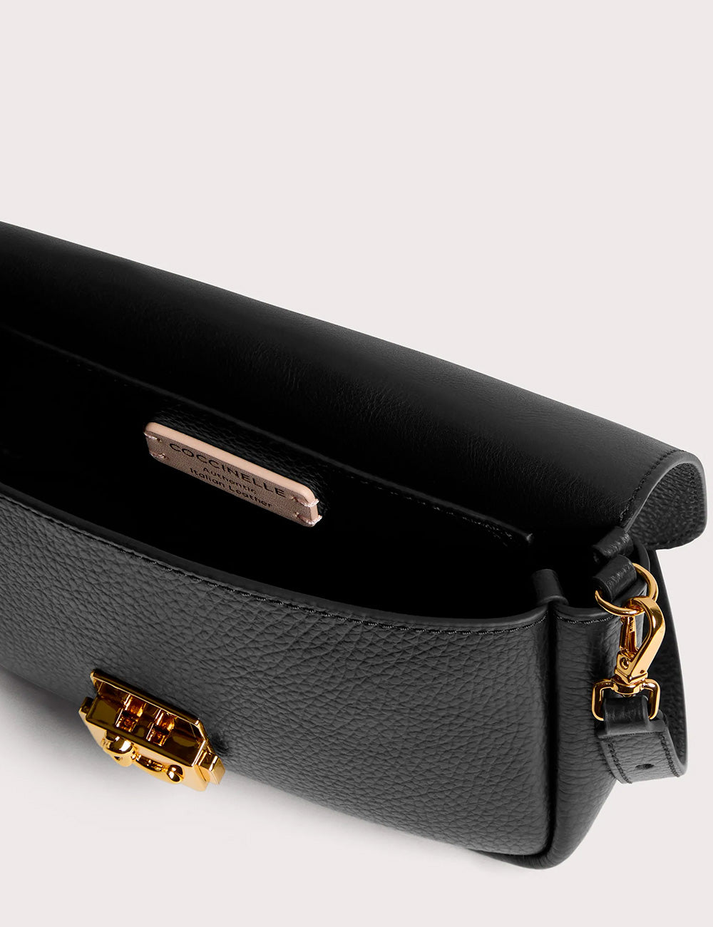 Black pebbled leather crossbody bag with gold-tone hardware and branded plaque coccinelle c-me lock mini noir