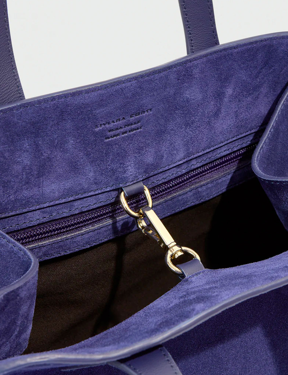 Deep blue suede tote bag with gold tone hardware and zipper closure liviana conti handbag madison bluette