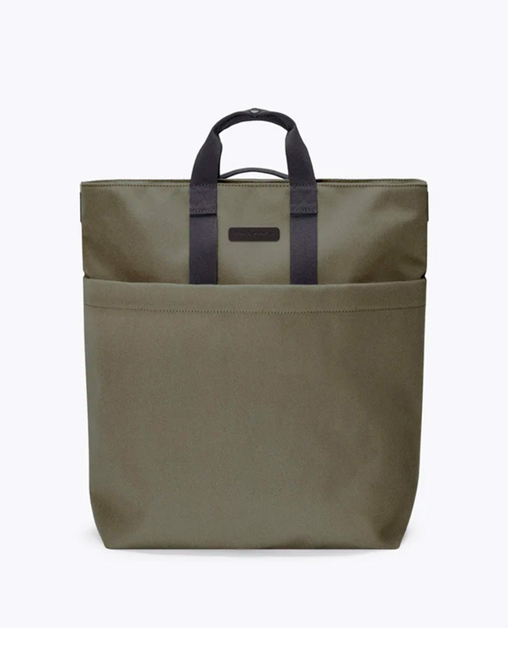 Olive green canvas tote bag with black leather handles and minimalist rectangular logo patch from ucon acrobatics nolan collection