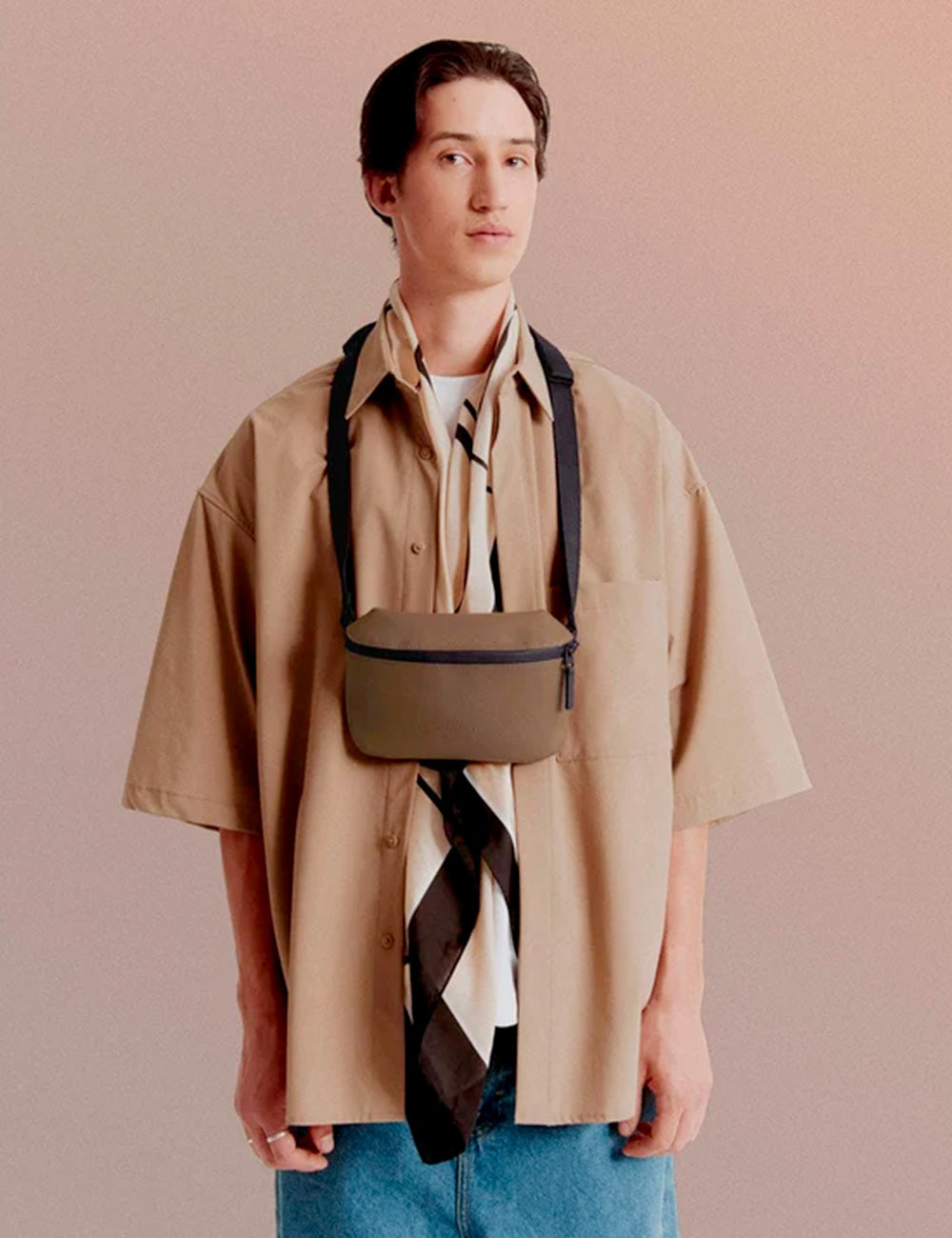 Minimalist tan crossbody pouch with black straps and zipper from ucon acrobatics jona infinity chestnut collection